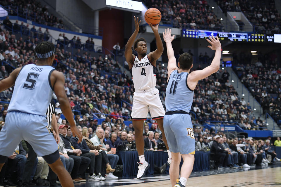 UConn's Nahiem Alleyne (4) shoots over Marquette's Tyler Kolek (11) in the first half of an NCAA college basketball game, Tuesday, Feb. 7, 2023, in Hartford, Conn. (AP Photo/Jessica Hill)