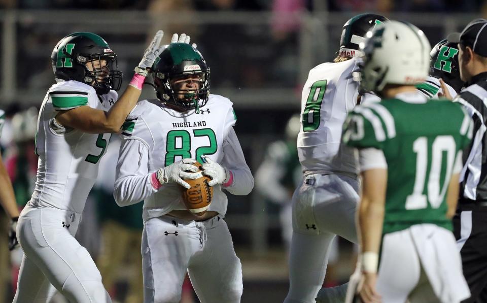 Highland defensive lineman Logan Marquis celebrates after recovering a ball fumbled by the Aurora Greenmen during the first half of a high school football game, Friday, Oct. 14, 2022, in Aurora, Ohio.