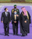 In this photo released by the Saudi Royal Palace, Saudi Crown Prince Mohammed bin Salman, right, welcomes Thai Prime Minister Prayuth Chan-ocha, at the Royal Palace in Riyadh, Saudi Arabia, Tuesday, Jan. 25, 2022. Thailand's prime minister arrived in Saudi Arabia on Tuesday for the first high-level meeting since relations between the nations soured three decades ago over a sensational jewelry heist that led to a diplomatic row and string of mysterious killings. (Bandar Aljaloud/Saudi Royal Palace via AP)
