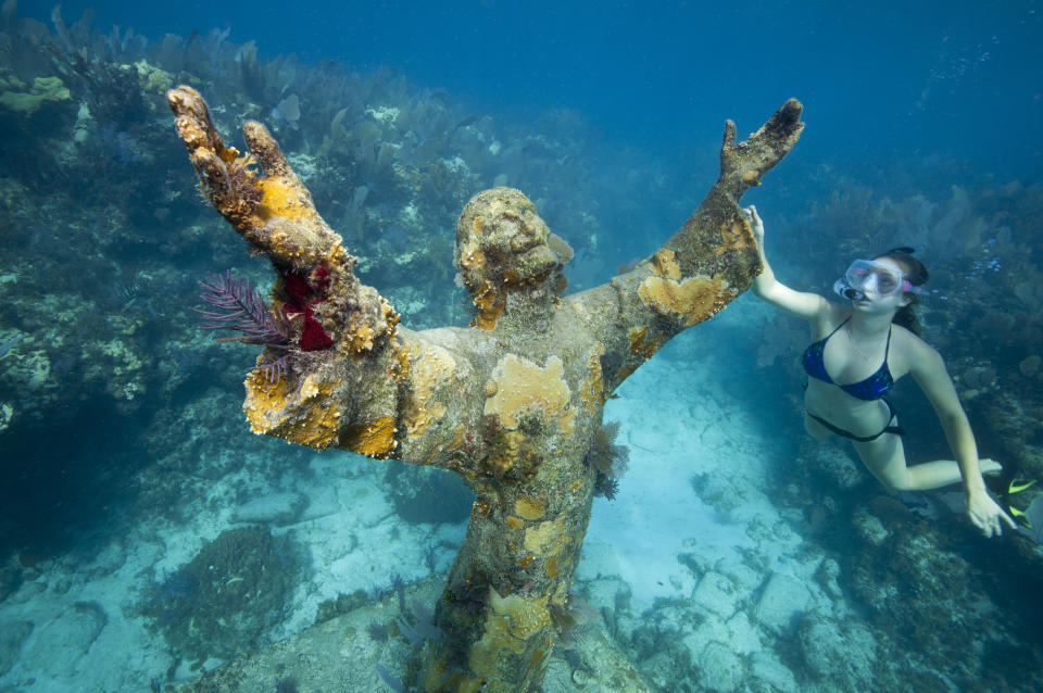 The Statue of Christ of the Abyss reaches out to the underwater world.