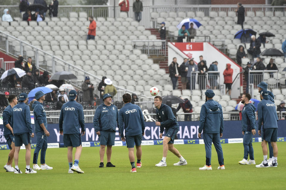 England players enjoy a bit of football as they wait for the rain to stop so they can start the fifth day of the fourth Ashes Test match between England and Australia at Old Trafford, Manchester, England, Sunday, July 23, 2023. (AP Photo/Rui Vieira)