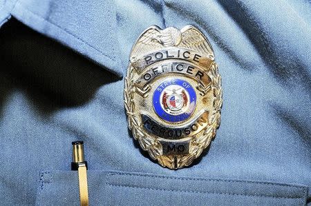 Officer Darren Wilson's police badge is pictured in this handout evidence photo from the August 9 Ferguson Police shooting of Michael Brown in Ferguson, released by the St. Louis County Prosecutor's Office on November 24, 2014. REUTERS/St. Louis County Prosecutor's Office/Handout via Reuters