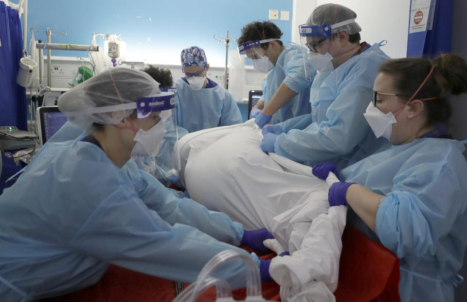 FILE - In this Wednesday, Jan. 27, 2021 file photo Critical Care staff prone a COVID-19 patient on the Christine Brown ward at King's College Hospital in London. The scale of Britain's coronavirus outbreak can seem overwhelming, with tens of thousands of new infections and more than 1,000 deaths added each day. (AP Photo/Kirsty Wigglesworth, File)