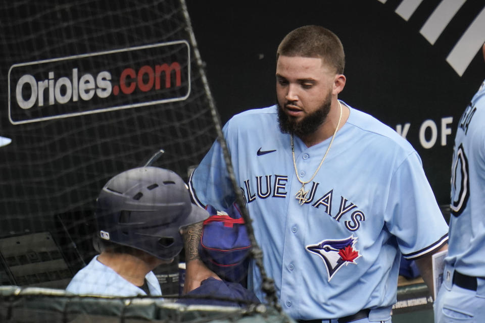 Toronto Blue Jays starting pitcher Alek Manoah heads to the clubhouse after he was ejected in the fourth inning of a baseball game, Saturday, June 19, 2021, in Baltimore. The incident happened as a result of Manoah hitting Orioles' Maikel Franco with a pitch after Manoah gave up back-to-back home runs to Ryan Mountcastle and DJ Stewart. Also seen is Blue Jays' catcher Reese McGuire, second from left. (AP Photo/Julio Cortez)