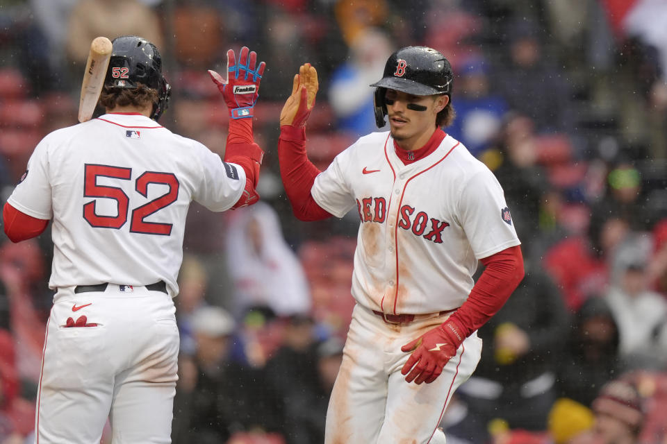 Boston Red Sox's Jarren Duran, right, celebrates with Wilyer Abreu, left, after scoring on a balk in the sixth inning of a baseball game against the Cleveland Guardians, Thursday, April 18, 2024, in Boston. (AP Photo/Steven Senne)