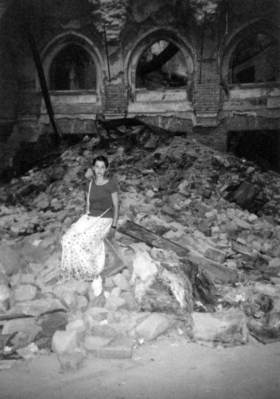 A young Nadja, sitting on the rubble of the inside of the National Public Library in Sarajevo in 1996.<span class="copyright">Courtesy Nadja Halilbegovich</span>