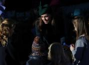 Britain's Catherine, the Duchess of Cambridge, greets children as she leaves a Christmas Day morning service at the church on the Sandringham Estate in Norfolk, eastern England, December 25, 2013. REUTERS/Andrew Winning (BRITAIN - Tags: ROYALS RELIGION)