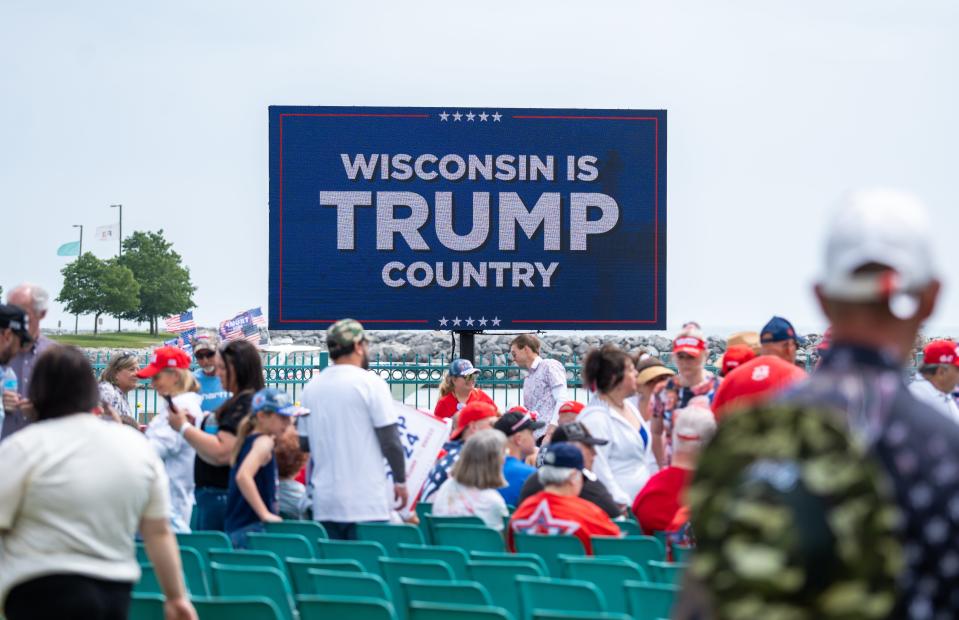 People begin to take their seats as former President Donald Trump is scheduled to speak at a rally on Tuesday June 18, 2024 at Racine Festival Park in Racine, Wis.