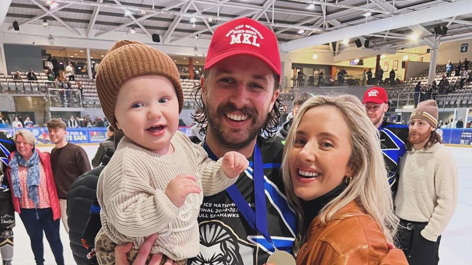 Liam with wife and baby on ice rink