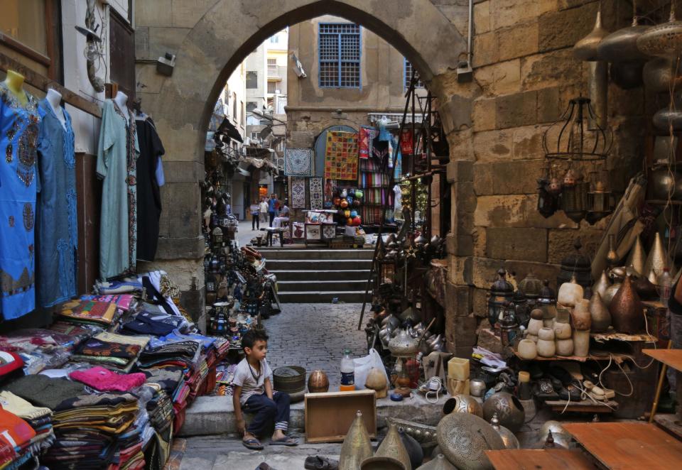 An young Egyptian vendor waits for customers in the Khan El-Khalili market, normally a popular tourist destination, in Cairo, Egypt, Monday, Sept. 9, 2013. Before the 2011 revolution that started Egypt's political roller coaster, sites like the pyramids were often overcrowded with visitors and vendors, but after a summer of coup, protests and massacres, most tourist attractions are virtually deserted to the point of being serene. (AP Photo/Lefteris Pitarakis)