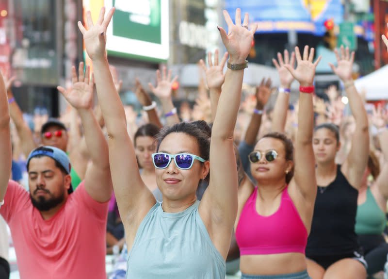 People attend a yoga class in celebration of the summer solstice at an 22nd annual all-day outdoor yoga event in Times Square in New York City on Thursday, June 20, 2024. Photo by John Angelillo/UPI