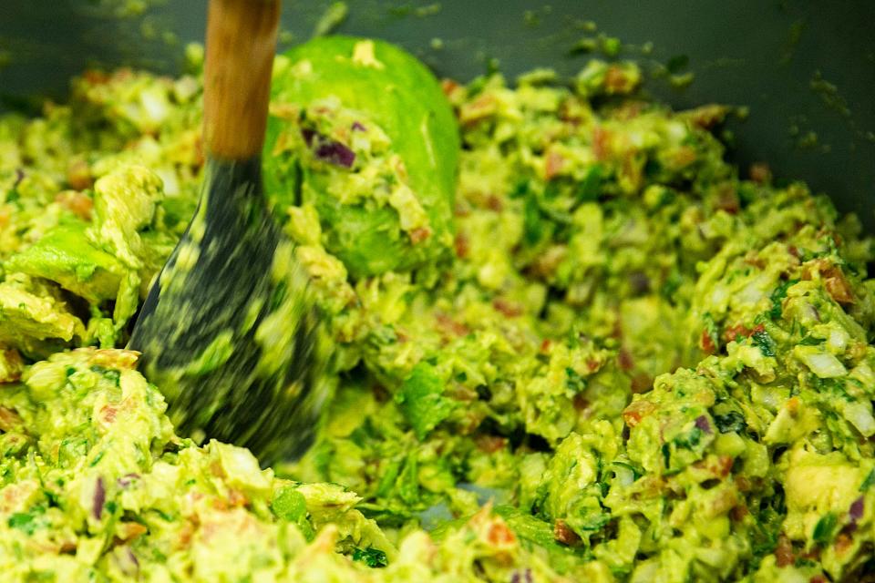 An employee mixes up guacamole at El Azul Mexican Market, Wednesday, Jan. 11, 2023, at 415 Community Drive in North Liberty, Iowa.