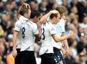 Tottenham Hotspur's Christian Eriksen (R) and Gylfi Sigurdsson (L) are both congratulated by team mates after Sigurdsson scored a goal during their English Premier League soccer match against Norwich City at White Hart Lane in London September 14, 2013.