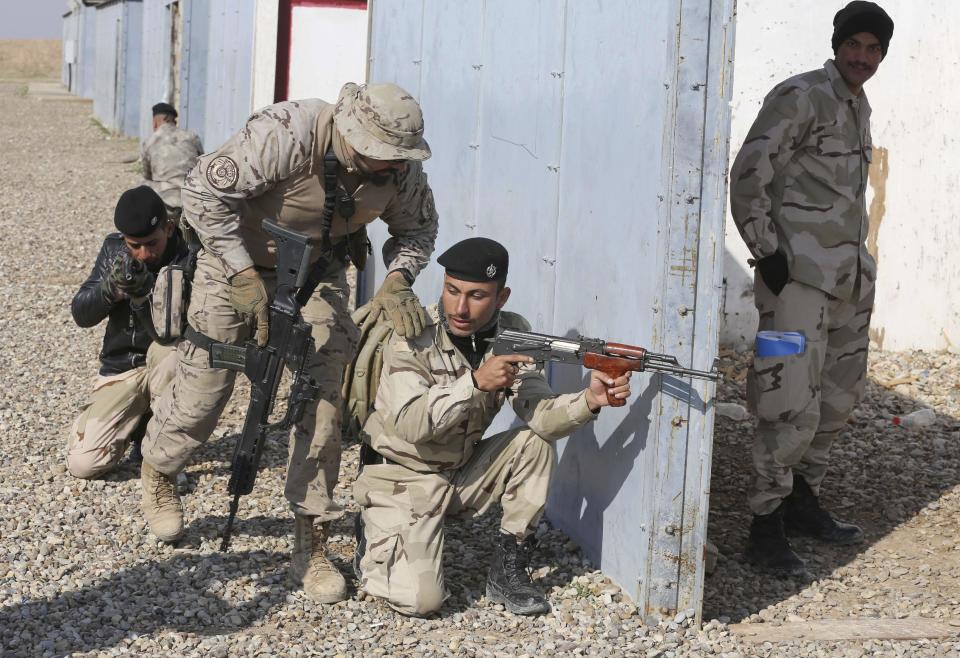 In this Wednesday, Feb. 1, 2017 photo, Nineveh police forces train with Spanish coalition members at Basmaya base 40 kilometers southeast of Baghdad, Iraq. The U.S.-led coalition is planning for the day Iraq will be free of the Islamic State group, ramping up the training of a future Mosul police force -- even as the battle for the city is temporarily on hold. The security forces are expected to move into villages of Ninevah province around Mosul and into parts of the city recently retaken from IS. The Iraqi military declared Mosul’s eastern half “fully liberated” in January and is now preparing to battle for the city’s western sector. (AP Photo/Karim Kadim)