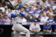 Los Angeles Dodgers' Freddie Freeman follows the flight of his RBI-double off Colorado Rockies relief pitcher Robert Stephenson in the seventh inning of a baseball game, Sunday, July 31, 2022, in Denver. (AP Photo/David Zalubowski)