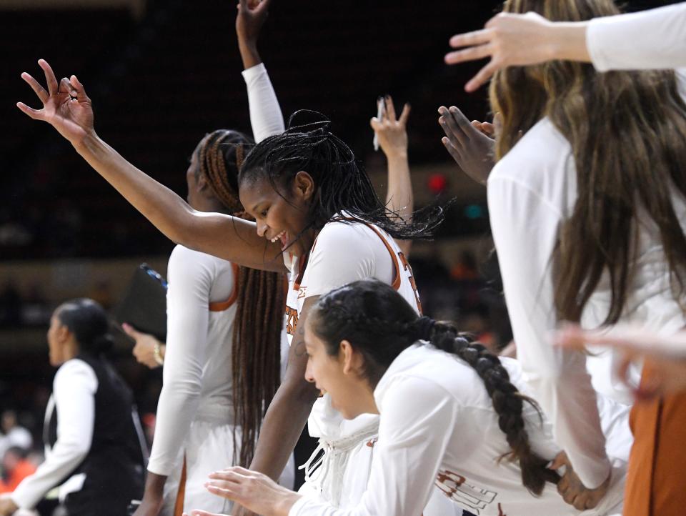 Texas forward Khadija Faye, center, signals after a 3-pointer during the Longhorns' 64-57 win over Oklahoma State on Saturday at the Big 12 women's tournament. The Longhorns will play for the Big 12 championship on Sunday afternoon.