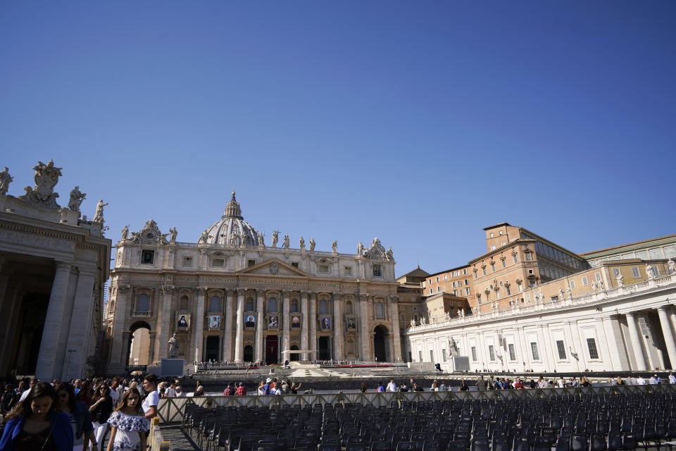 The tapestries of Roman Catholic Archbishop Oscar Romero, 3rd from left, and Pope Paul VI, 4th from left, hang from a balcony of the facade of St. Peter's Basilica at the Vatican, Saturday, Oct. 13, 2018. Pope Francis will canonize two of the most important and contested figures of the 20th-century Catholic Church, declaring Pope Paul VI and the martyred Salvadoran Archbishop Oscar Romero as models of saintliness for the faithful today. (AP Photo/Andrew Medichini)