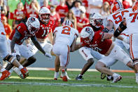 Clemson quarterback Cade Klubnik (2) runs the ball between North Carolina State safety Sean Brown (0) and linebacker Caden Fordham (10) with linebacker Payton Wilson (11) looking on during the first half of an NCAA college football game in Raleigh, N.C., Saturday, Oct. 28, 2023. (AP Photo/Karl B DeBlaker)