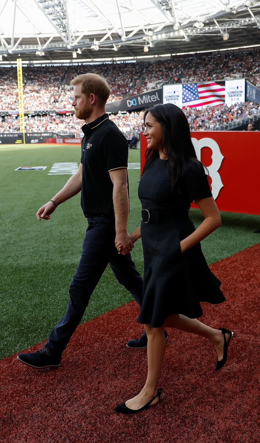 Prince Harry and Meghan Markle walk out on to the pitch as they attend the London Series at Queen Elizabeth Olympic Park.