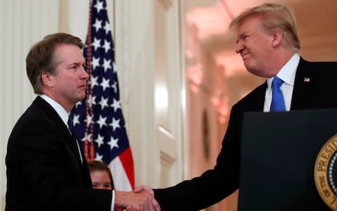 President Donald Trump shakes hands with Judge Brett Kavanaugh his Supreme Court nominee - Credit: Alex Brandon/AP