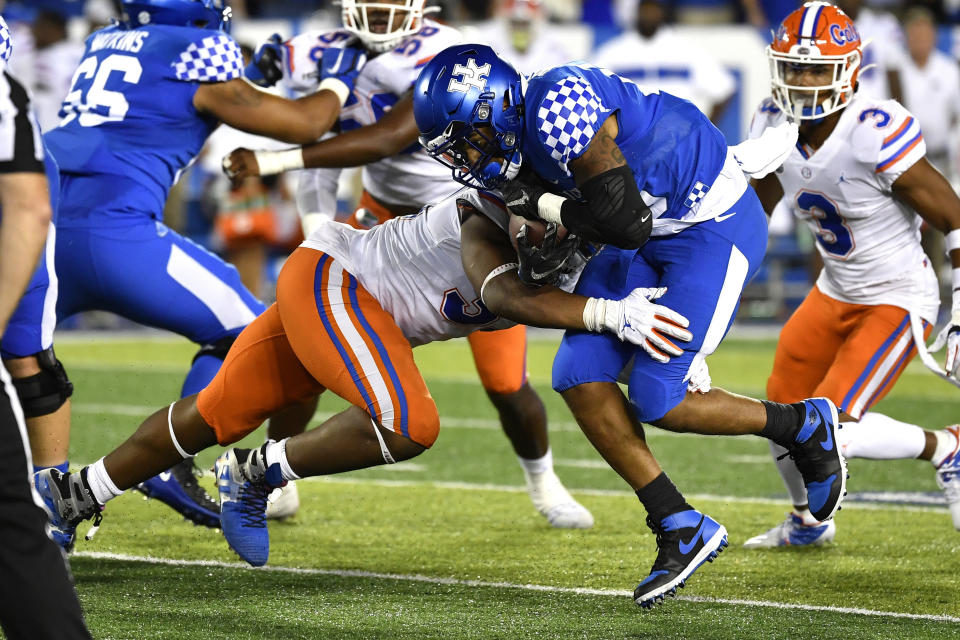 Kentucky running back Asim Rose, front right, is hit by Florida linebacker David Reese II (33) during the second half of an NCAA college football game in Lexington, Ky., Saturday, Sept. 14, 2019. (AP Photo/Timothy D. Easley)