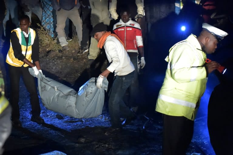 Volunteers carry the body of a victim killed in an oil tanker explosion near the town of Naivasha, Kenya, on December 11, 2016