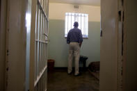 <p>President Barack Obama peers out from Section B, prison cell No. 5, on Robben Island, South Africa, Sunday, June 30, 2013. This was former South African president Nelson Mandela’s cell, where spent 18-years of his 27-year prison term on the island locked up by the former apartheid government. (AP Photo/Carolyn Kaster) </p>