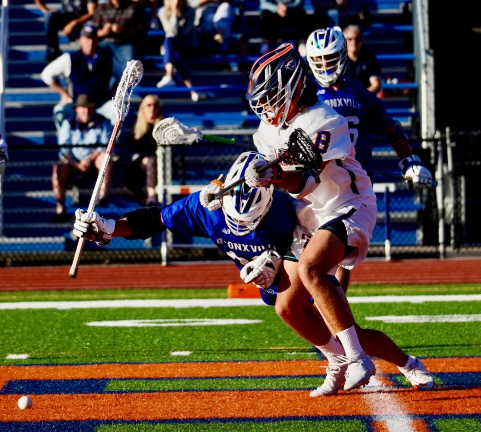 Bronxville's Wilder Burgin comes underneath Briarcliff's Luca Meola as they chase down a faceoff in the fourth quarter on May 9, 2022. The Broncos went on to win 10-9 in overtime.