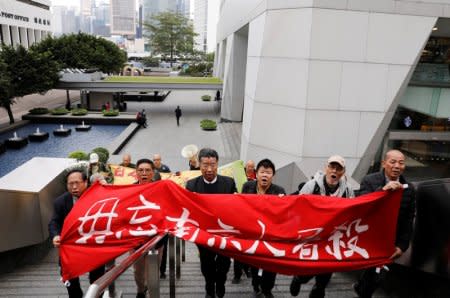 Protesters march to Japan's consulate to commemorate the 80th anniversary of the Nanjing Massacre, in Hong Kong, China December 13, 2017.  The banner reads,