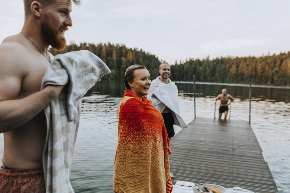 Smiling friends at lake (Getty Images/Johner RF)