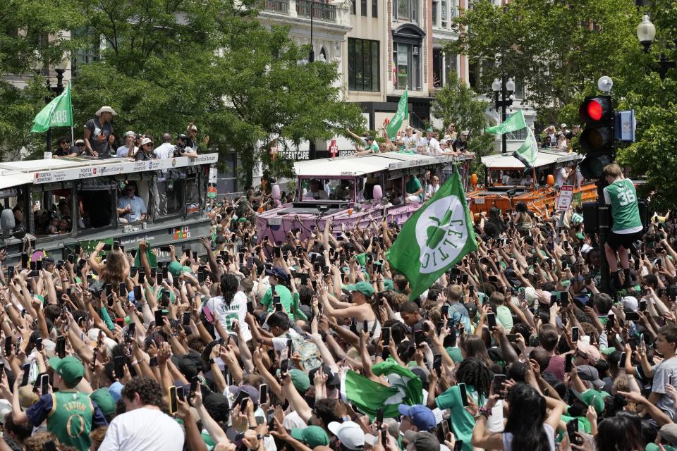 The Boston Celtics celebrate their NBA basketball championship win with a duck boat parade Friday, June 21, 2024, in Boston. (AP Photo/Michael Dwyer)