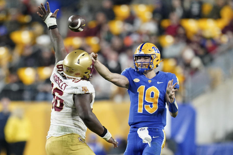 Pittsburgh quarterback Nate Yarnell (19) gets a pass off as he is pressured by Boston College defensive tackle Cam Horsley (96) during the second half of an NCAA college football game, Thursday, Nov. 16, 2023, in Pittsburgh. (AP Photo/Matt Freed)