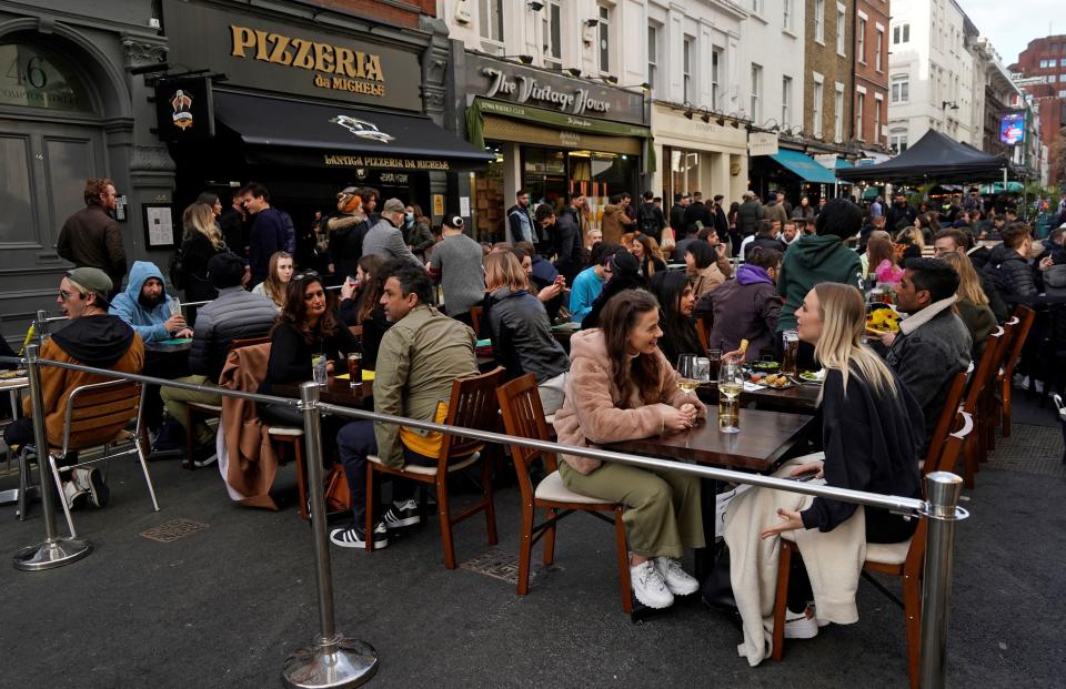 People drink in the street in the Soho area of London, on April 16, 2021 following step two of the government's roadmap out of England's third national lockdown. - Britons on Apri l12 toasted a significant easing of coronavirus restrictions, with early morning pints -- and much-needed haircuts -- as the country took a tentative step towards the resumption of normal life. Businesses including non-essential retail, gyms, salons and outdoor hospitality were all able to open for the first time in months in the second step of the government's roadmap out of lockdown. (Photo by Niklas HALLE'N / AFP) (Photo by NIKLAS HALLE'N/AFP via Getty Images)