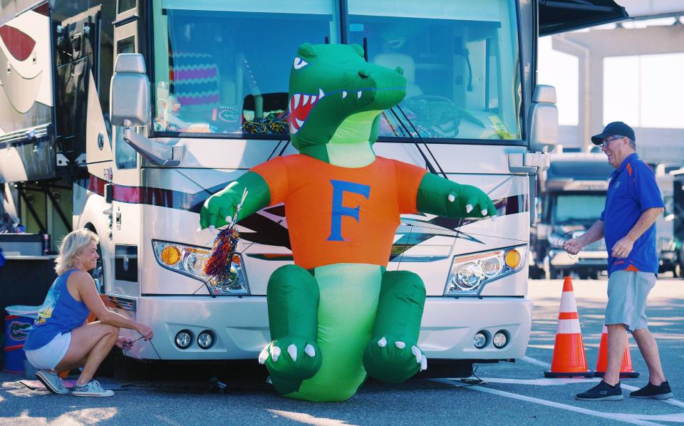 Linda and David Allen from Fleming Island secure their inflatable Florida Gator mascot to the front of their RV as they set up their encampment along Gator Alley for last year's Georgia-Florida game. The couple have been coming to the game for 40 years.
