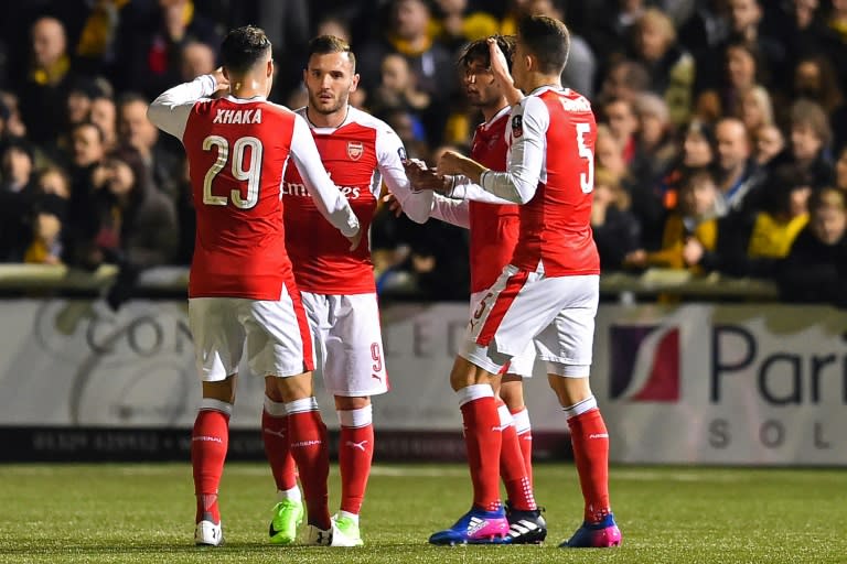 Arsenal's Spanish striker Lucas Perez (2nd L) celebrates with teammates after scoring the opening goal of the English FA Cup fifth round football match between Sutton United and Arsenal on February 20, 2017