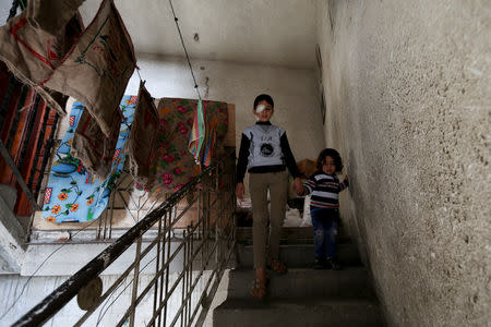 Palestinian boy Mohammad An-Najjar, 12, who was wounded in his eye during a protest at the Israel-Gaza border fence, walks down the stairs of their family house, in Khan Younis, in the southern Gaza Strip, January 21, 2019. REUTERS/Ibraheem Abu Mustafa