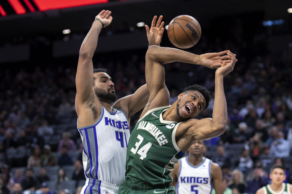 Milwaukee Bucks forward Giannis Antetokounmpo (34) is fouled by Sacramento Kings forward Trey Lyles (41) during the first quarter of an NBA basketball game in Sacramento, Calif., Wednesday, March 16, 2022. (AP Photo/José Luis Villegas)