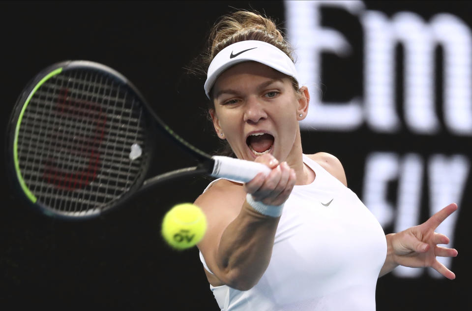 Romania's Simona Halep makes a forehand return to Britain's Harriet Dart during their second round singles match at the Australian Open tennis championship in Melbourne, Australia, Thursday, Jan. 23, 2020. (AP Photo/Dita Alangkara)