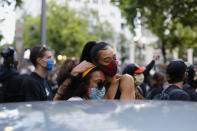 Two people embrace as protesters demonstrate in and around Pioneer Square in Portland, on Tuesday evening, June 2, 2020 as protests continued for a sixth night in Portland, demonstrating against the death of George Floyd. (Brooke Herbert/The Oregonian via AP)