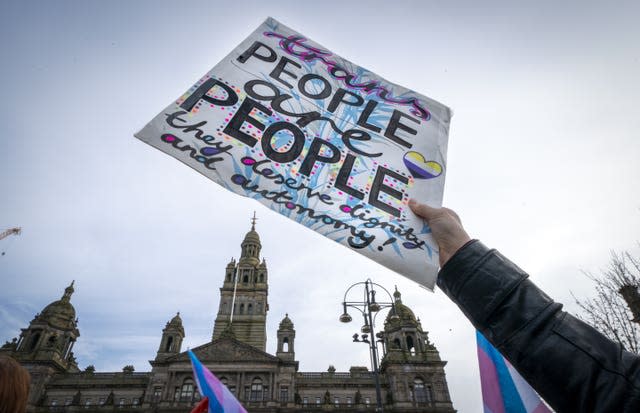 Sign saying 'trans people are people. They deserve dignity and autonomy'