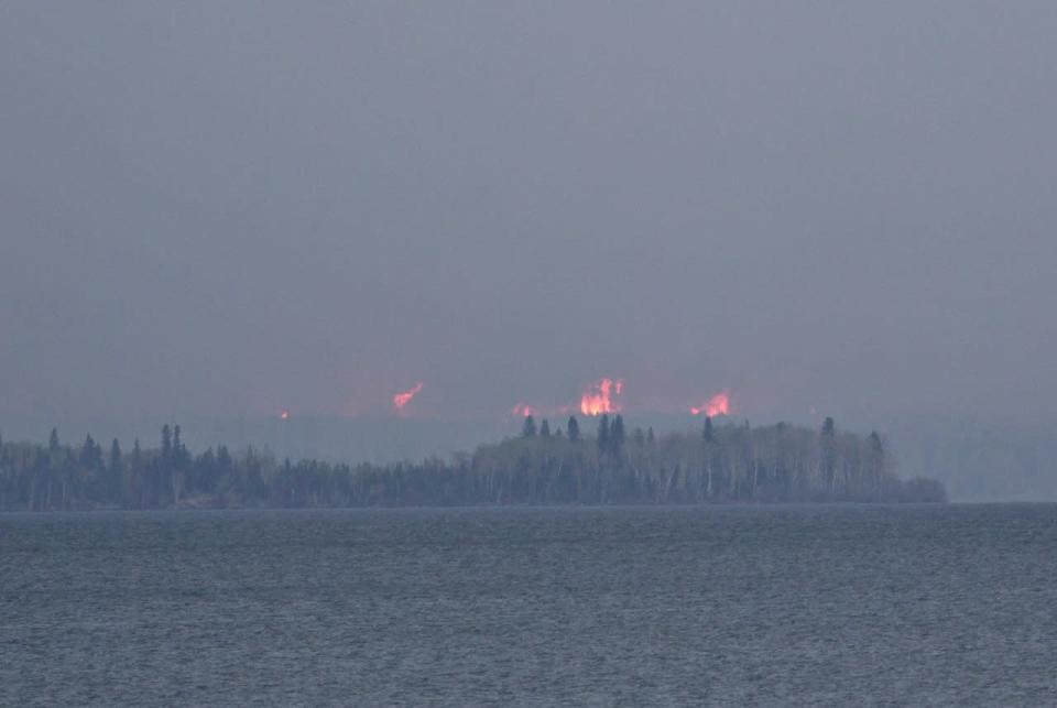 Wildfires burn across Gregoire Lake near Fort McMurray, Alta., on Thursday, May 5, 2016. THE CANADIAN PRESS/Jason Franson