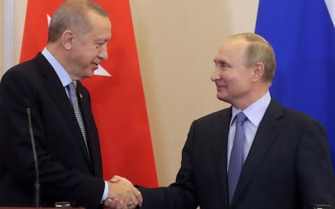 Russian President Vladimir Putin (R) shakes hands with Turkish President Recep Tayyip Erdogan (L) during a joint news conference following Russian-Turkish talks in the Black sea resort of Sochi, Russia, last month - Credit: Reuters