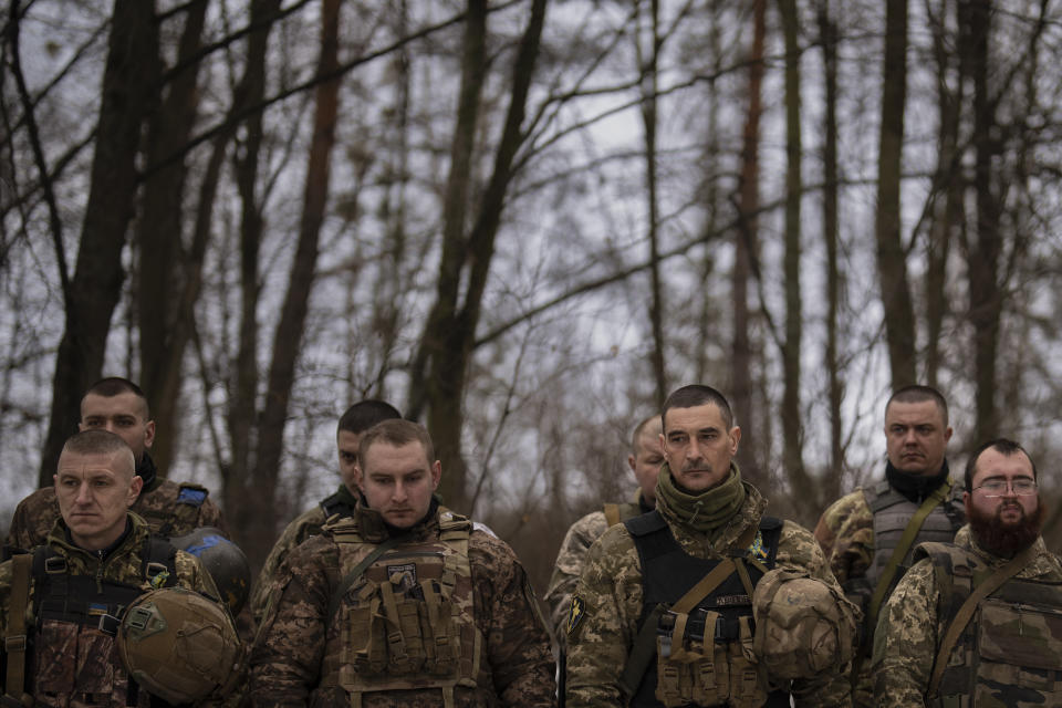 FILE - Ukrainian servicemen of the Prince Roman the Great 14th Separate Mechanized Brigade stand in formation during a flag ceremony where some of them were honored for their bravery and accomplishments in battle, in the Kharkiv area, Ukraine, Saturday, Feb. 25, 2023. Grueling artillery battles have stepped up in recent weeks in the vicinity of Kupiansk, a strategic town on the eastern edge of Kharkiv province by the banks of the Oskil River as Russian attacks intensifying in a push to capture the entire industrial heartland known as the Donbas, which includes the Donetsk and the Luhansk provinces. (AP Photo/Vadim Ghirda, File)