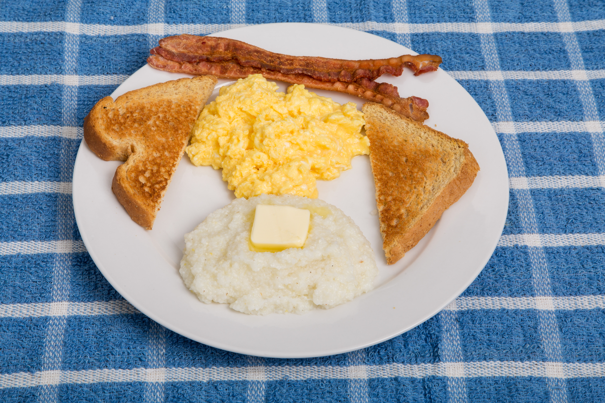 Plate of bacon, eggs, grits, and toast