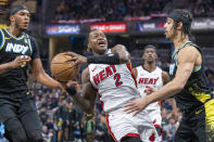 Miami Heat guard Terry Rozier (2) shoots while being defended by Indiana Pacers center Myles Turner, left, and guard Andrew Nembhard (2) during the first half of an NBA basketball game in Indianapolis, Sunday, April 7, 2024. (AP Photo/Doug McSchooler)