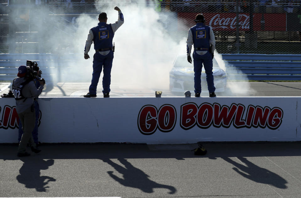 Chase Elliott does a celebratory burnout in front of his pit crew after winning a NASCAR Cup Series auto race at Watkins Glen International, Sunday, Aug. 4, 2019, in Watkins Glen, N.Y. (AP Photo/John Munson)