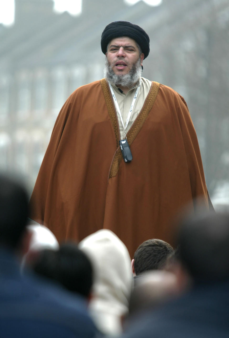 FILE - In this March 28, 2003 file photo, radical Muslim cleric Mustafa Kamel Mustafa prays in a street outside his Mosque in north London. Mustafa faces charges he conspired to support al-Qaida by trying in 1999 to set up a terrorist training camp in Bly, Ore., and by helping abduct two American tourists and 14 others in Yemen in 1998. Jury selection for his terrorism trial begins in New York on Monday, April 14, 2014. (AP Photo/Alastair Grant, File)