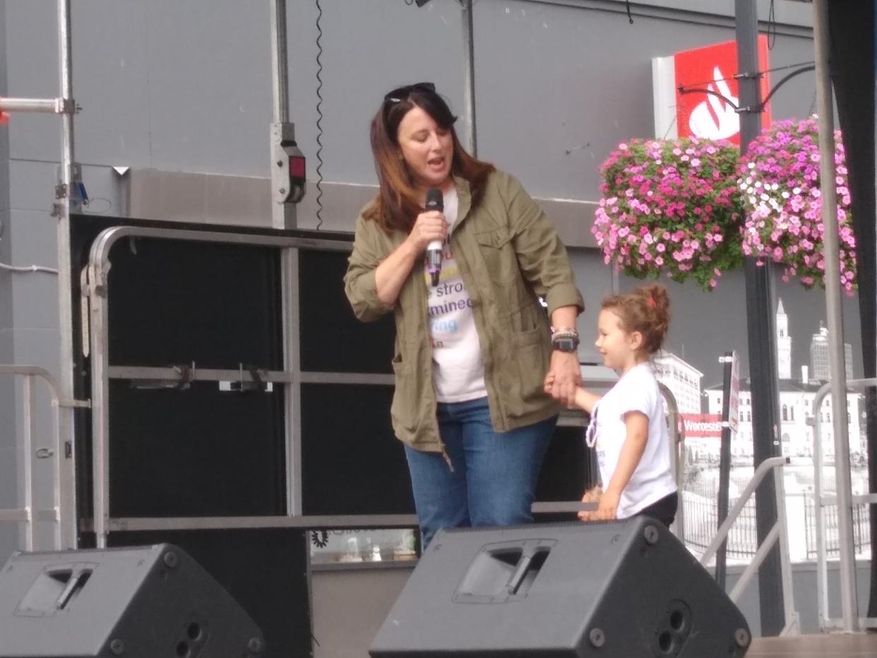 Sen. Robyn Kennedy, D-Worcester, accompanied by her niece, speaks Saturday from the main stage at the Pride Worcester Festival.