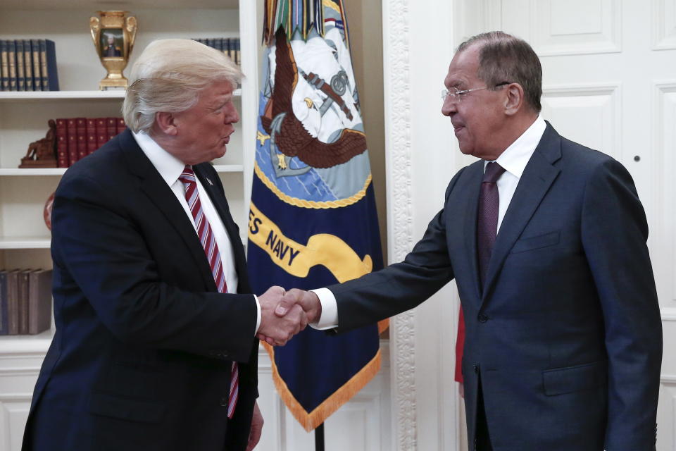 President Donald Trump shakes hands with Russia's Foreign Minister Sergei Lavrov as they meet for talks in the Oval Office.