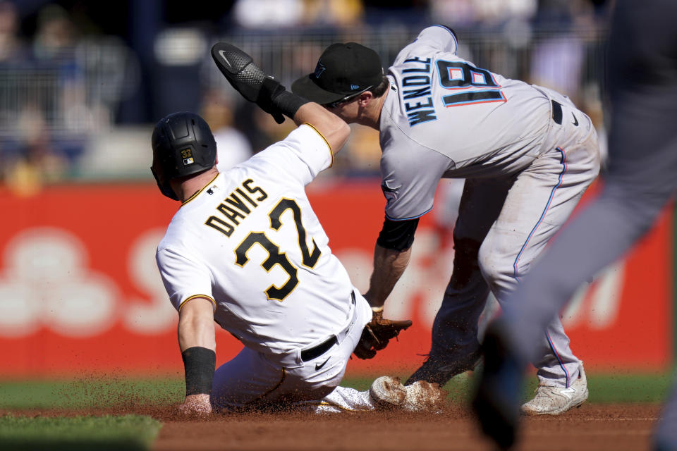 Miami Marlins shortstop Joey Wendle tags out Pittsburgh Pirates' Henry Davis on a steal attempt at second base during the second inning of a baseball game in Pittsburgh, Sunday, Oct. 1, 2023. (AP Photo/Matt Freed)